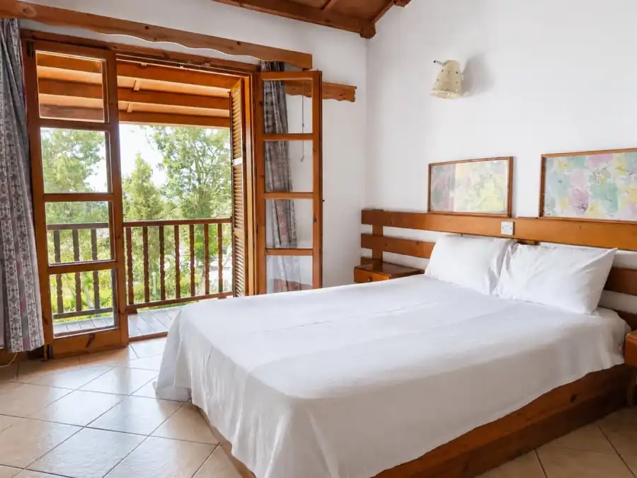 Poolside Bungalow bedroom with rustic balcony